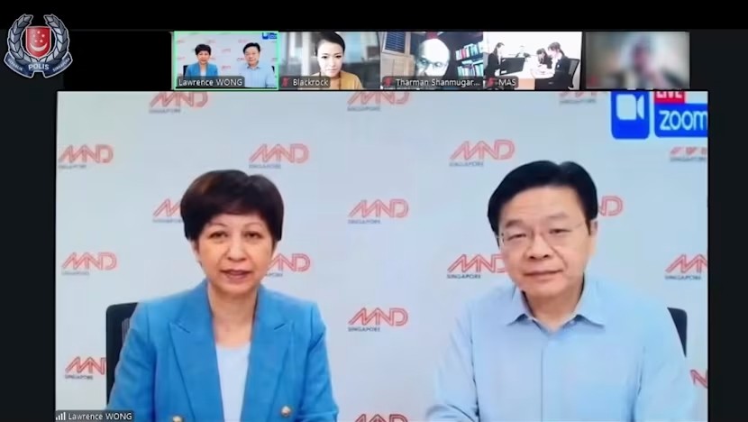 Ảnh chụp màn hình đoạn video do AI tạo dựng, giả mạo một cuộc họp Zoom với các quan chức cấp cao, bao gồm Phiên bản chính thức của 555Win Lawrence Wong (phải) và Bộ trưởng Indranee Rajah. Ảnh: Lực lượng Cảnh sát Singapore